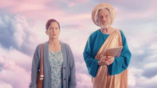 A woman stands beside an older man in a colorful robe against a background of clouds